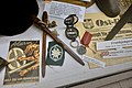 Display with recruitment brochure pamphlet for Frontkjemper (Norwegian Waffen-SS volunteers), tent pegs Zeltbahn, Gebirgsjäger Edelweiss emblem, Eastern Medal, compass, Ost-Front newspape, etc.; Lofoten War Museum, Norway.