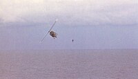 RVNAF pilot jumps from his Huey after dropping evacuees on USS Midway