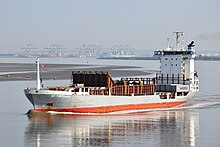 A medium-size container ship sailing in very calm waters