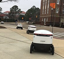A line of Starship Technologies delivery robots at the University of Mississippi