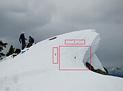 A cornice of snow about to fall. Cracks in the snow are visible in area (1). Area (3) fell soon after this picture was taken, leaving area (2) as the new edge.