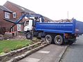 Truck with clamshell grab on arm, south Manchester, England, 27 July 2009