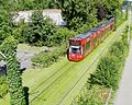 Freiburg Combino on green track.