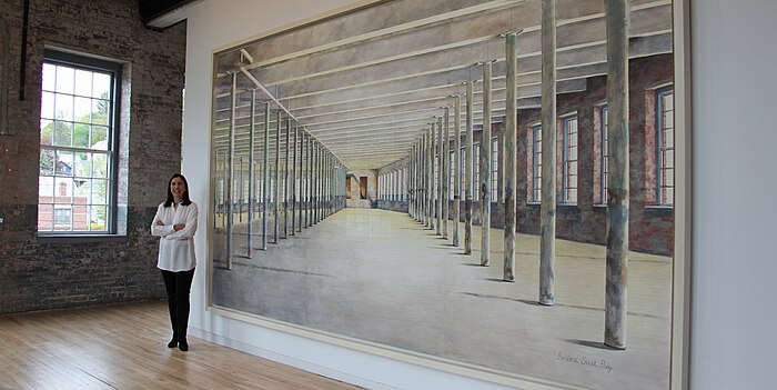 Barbara Prey on front of her 8 x 15 feet painting at MASS MoCA