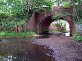 The river passes beneath the railway, north of Fulliford Passage