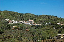 Benaque in Macharaviaya. Town with Iglesia mudejar church (former mosque) in hill background.