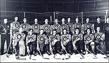 Black and white team photo of the players in uniform and wearing hockey equipment