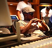 A picture of a man sitting in a recording studio