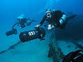 Divers with canister lights using Goodman handles