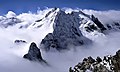 Mountain peaks poking through ragged stratus clouds in the Swiss Alps.