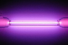 Vial containing a violet glowing gas