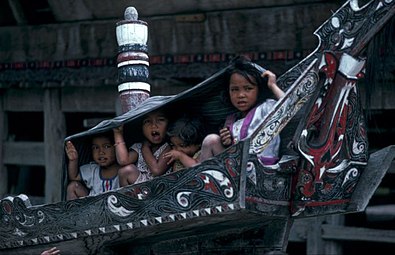 Toba Batak children in a solu at Simanindo.