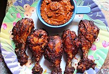 African chicken thighs and a bowl of piri piri sauce