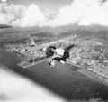 A Vickers Vildebeest Mk III of No. 36 Squadron RAF in flight over Singapore City.