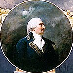 Painting of a black-moustached man in a white 18th century wig. He wears a blue 1790s style military coat with gold trim.