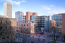 Glass-faced skyscrapers abutting brick-lined urban area