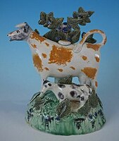 Prattware cow and calf bocage figure, underglaze colours, circa 1800