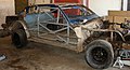 A race car stripped down to its roll cage and firewalls