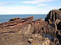 Hutton's angular unconformity at Siccar Point where Famennian age (371–359 Ma) Devonian Old Red Sandstone overlies Llandovery age (444–433 Ma) Silurian greywacke[14]