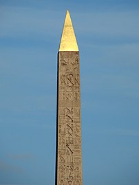 Hieroglyphs on the upper obelisk. The Pharaoh on his throne is portrayed at the top