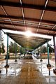 students seek shelter from rain under the solar energy plates