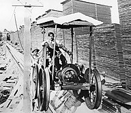 An electric-powered flume cart raises boards to the tops of the drying piles.[13]: 101 