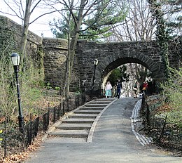 Stone archway and path under Linden Terrace, with small steps