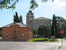 Public square with trees and greenspace between the Norfolk County offices and the old court house