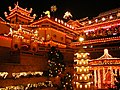 Temple at night illuminated with light from decorations