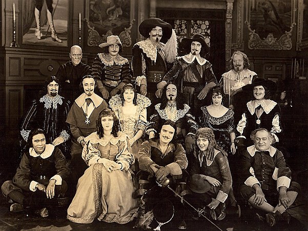 Front row: Charles Stevens, Marguerite De La Motte, Douglas Fairbanks, Mary Pickford (guest), Sidney Franklin. Second row: Boyd Irwin, Nigel De Brulier, Mary MacLaren, Adolphe Menjou, Barbara La Marr, Thomas Holding. Back row: Lon Poff, Eugene Pallette, George Siegmann, Léon Bary, Willis Robards.