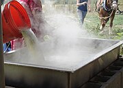 Adding freshly squeezed juice to a simmering pan of syrup on an open fire, much as it was done in the 19th century