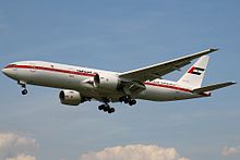 Aircraft landing approach. Side view of a twin-engine jet in flight with flaps and landing gear extended.