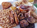 Image 77The full breakfast is among the best known British dishes, consisting of fried egg, sausage, bacon, mushrooms, baked beans, toast, fried tomatoes, and sometimes white or black pudding. (from Culture of the United Kingdom)