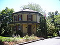 Modest sized but decorative timber frame house, seen here painted in 'heritage' colors which may reflect the original color scheme. Octagon House, Barrington, Illinois (built 1860).