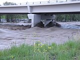 Flood waters rush by the Okotoks 32nd Street bridge on the evening of June 20, 2013.