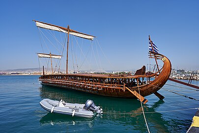 Trireme near a modern boat