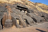 General view, with the top of the chaitya entrance columns visible, and the outside stupa