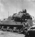 A captured Type 94 tankette with a damaged turret, on the engine deck of a USMC M4 Sherman tank at Kwajalein