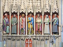 Masonry screen with painted statues