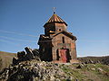 Church of Saint Sargis atop a stone outcrop in the middle of the village east of the fortress.