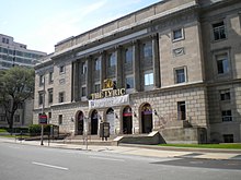 A neoclassical four-story building in an urban area