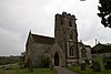 Stone building with arched windows and a square tower.