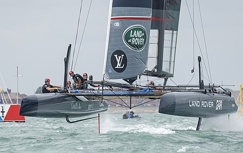 Land Rover BAR's AC45f sailing on hydrofoils with one daggerboard raised above the water.