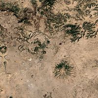 A satellite image of the volcano (center) and the surrounding area