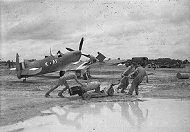 A Supermarine Spitfire Mark VIII of No 607 Squadron is prepared by an RAF crew during monsoon conditions at Mingaladon for a sortie against the Japanese break-out attempt at Sittang