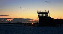 A picture of RAF Barkston Heath with snow in the foreground and CB clouds in the background.