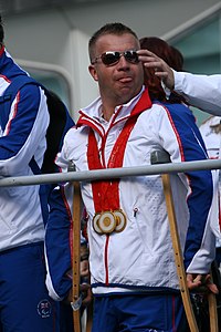 Photo of Pearson wearing three gold medals