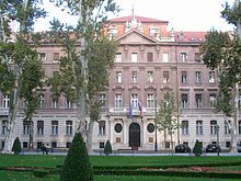 Building in formal style behind scattered trees