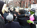 Protesters share a group hug with each other