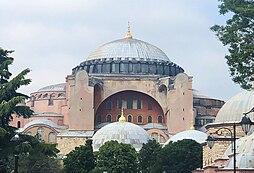 A photograph of a large blue-domed structure at the centre with at least four smaller white-domed structures at the right